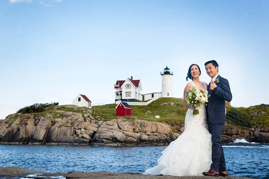 Coastal wedding portrait by a lighthouse