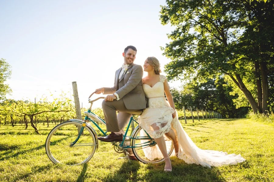 Fun vineyard wedding portrait on a bicycle