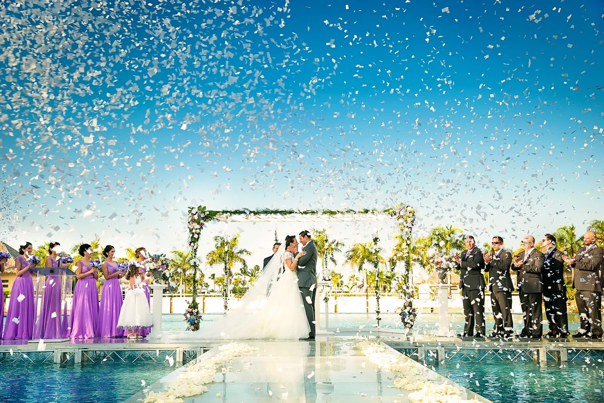 Bright destination wedding ceremony with confetti